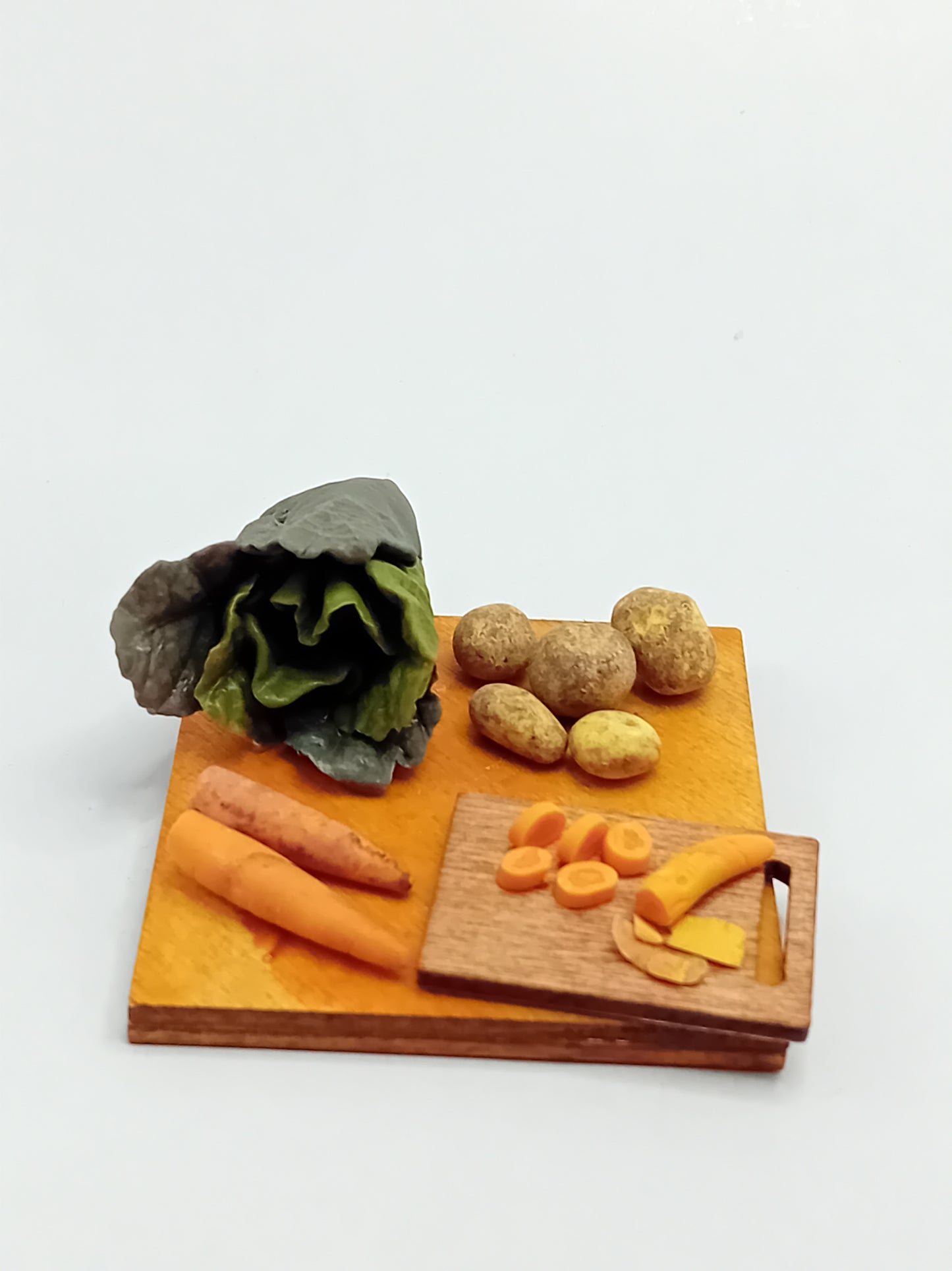 1:12 scale Polymer clay Green cabbage, carrot sand potatoes sat on a wooden chopping board placed on a 5cm x 5cm display board.