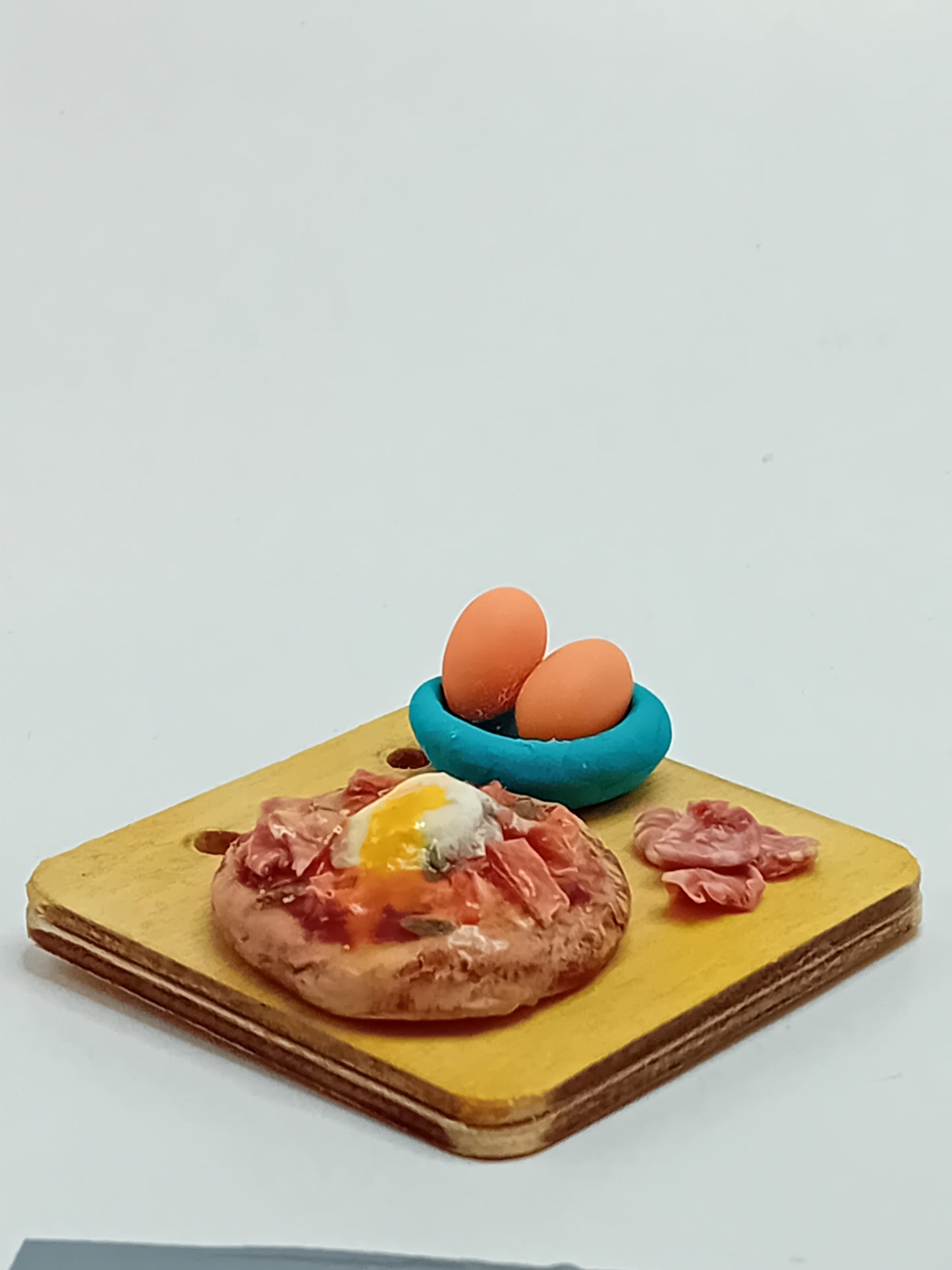 Pizza feast with egg and Spanish Jamon made from polymer clay on 5cm x 5cm wooden serving board.