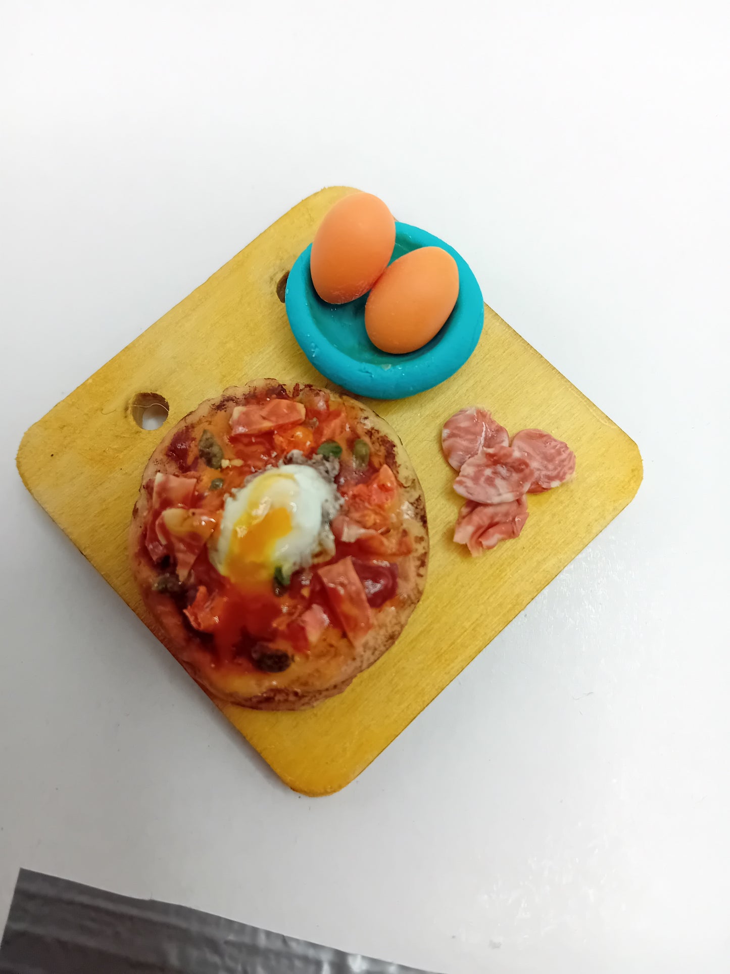 Pizza feast with egg and Spanish Jamon made from polymer clay on 5cm x 5cm wooden serving board.