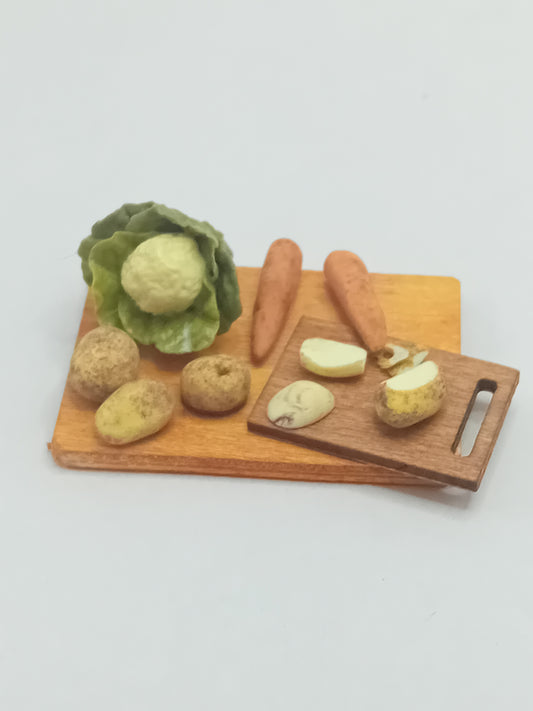 1:12 scale cauliflower, carrots and potatoes peeled on a chopping board placed on wooden display board 5cm x 4cm.