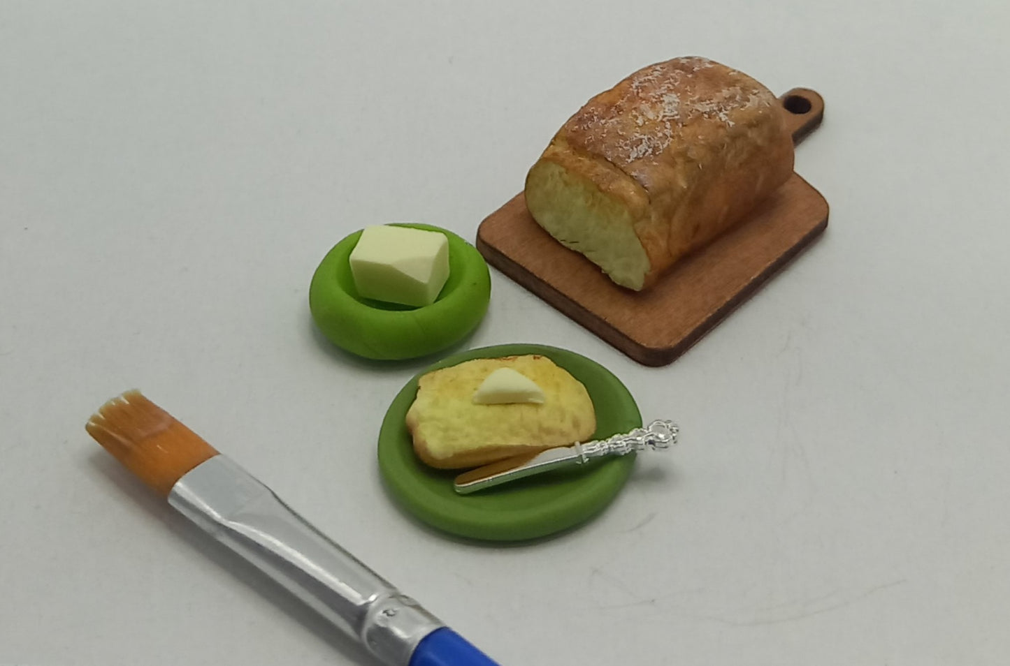 1:12 scale polymer miniature: Freshly baked polymer toast with butter. 8 pieces, not glued.